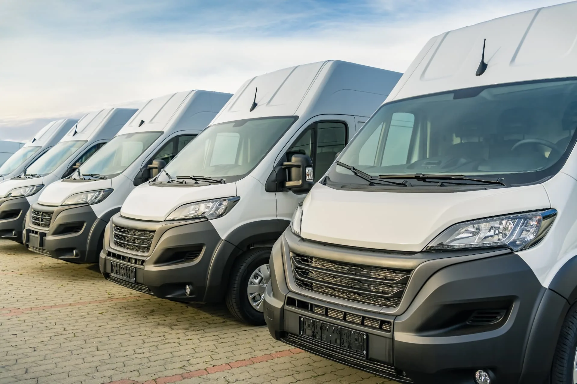 Row of white work vans