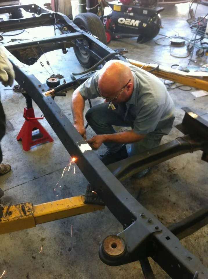 Technician welding a vehicle frame at Scott's Auto Repair in West Columbia, SC