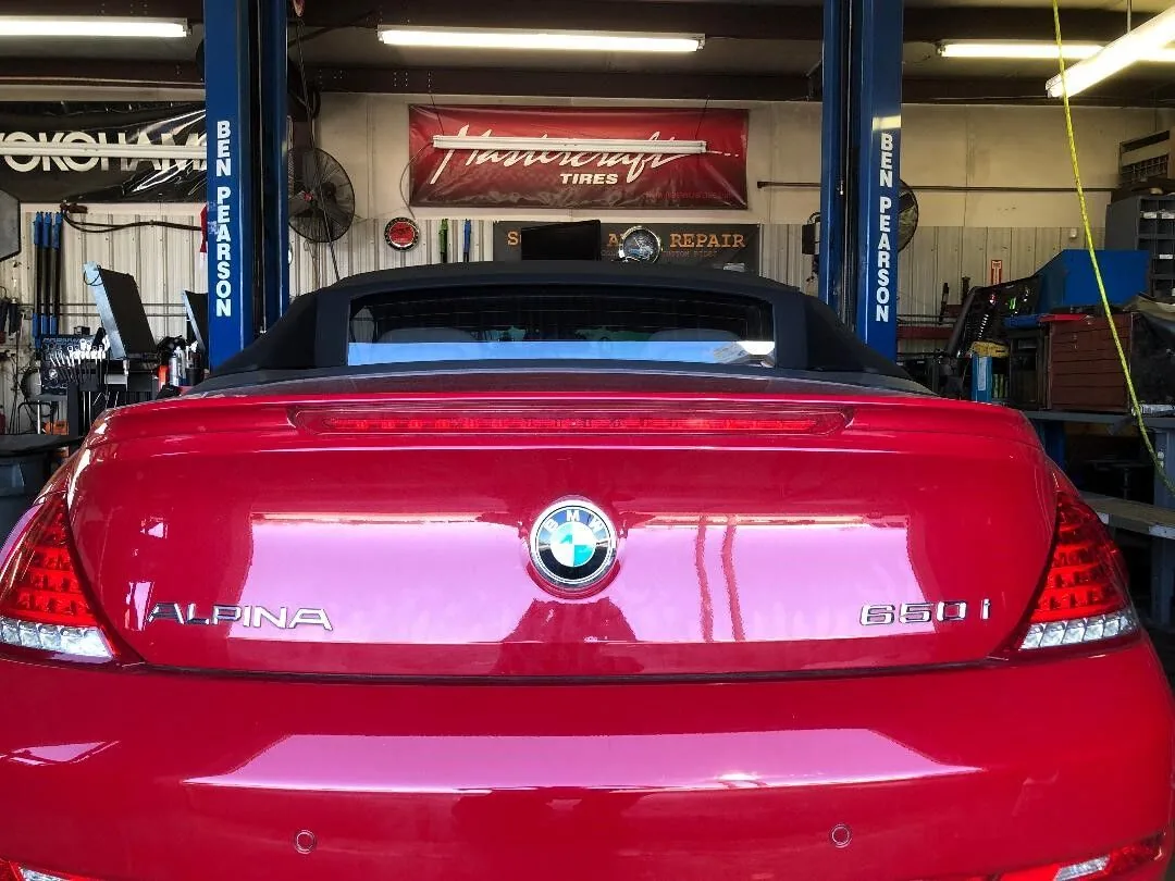 Rear view of a red BMW in the repair bay at Scott's Auto Repair in West Columbia, SC