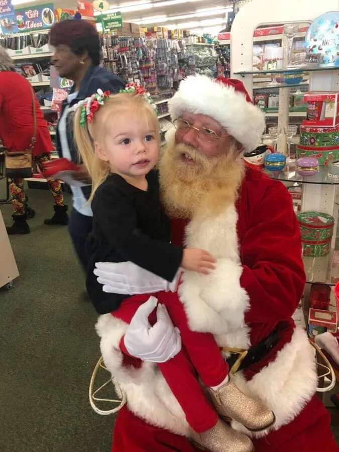 Child with Santa at the Scott's Auto Santa Claus event in West Columbia, SC