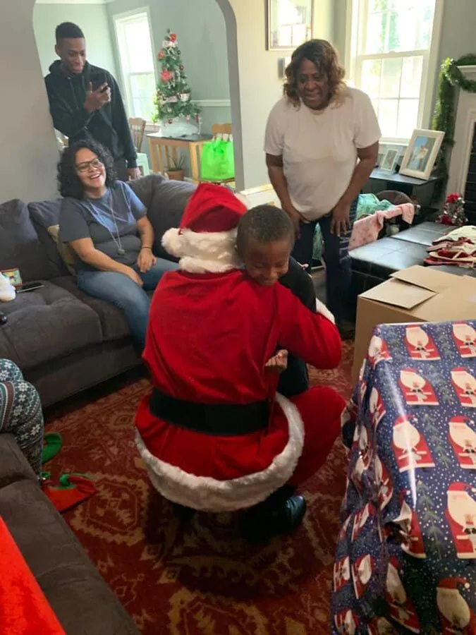 Family visiting Santa at the Scott's Auto Santa Claus event in West Columbia, SC