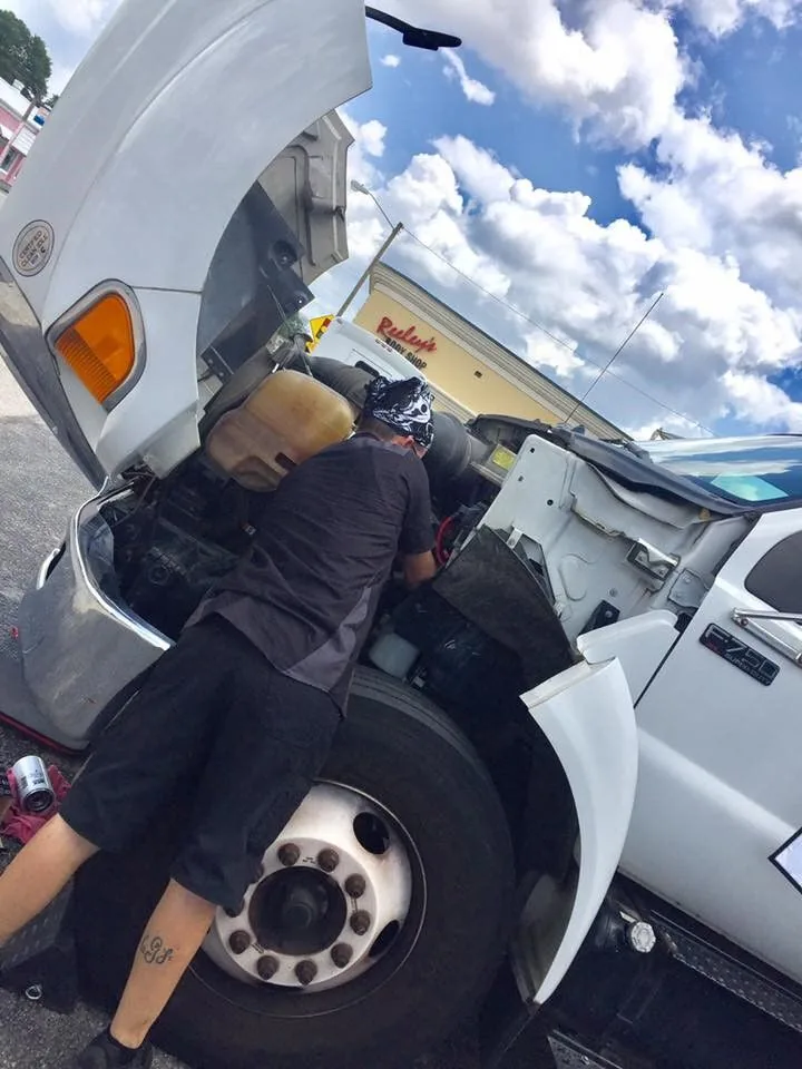 Technician working on a diesel truck engine in West Columbia, SC