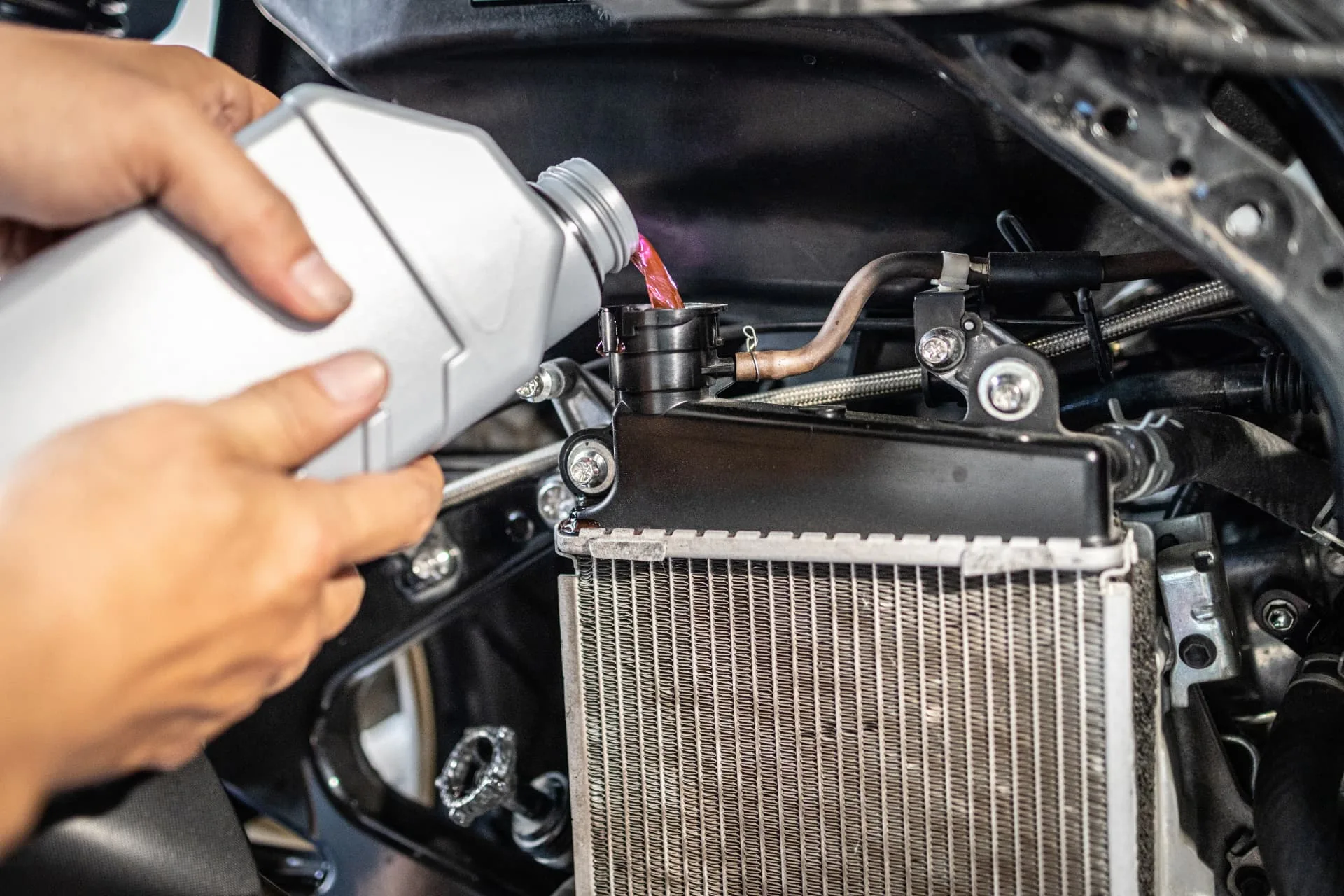 Pouring coolant into a new radiator