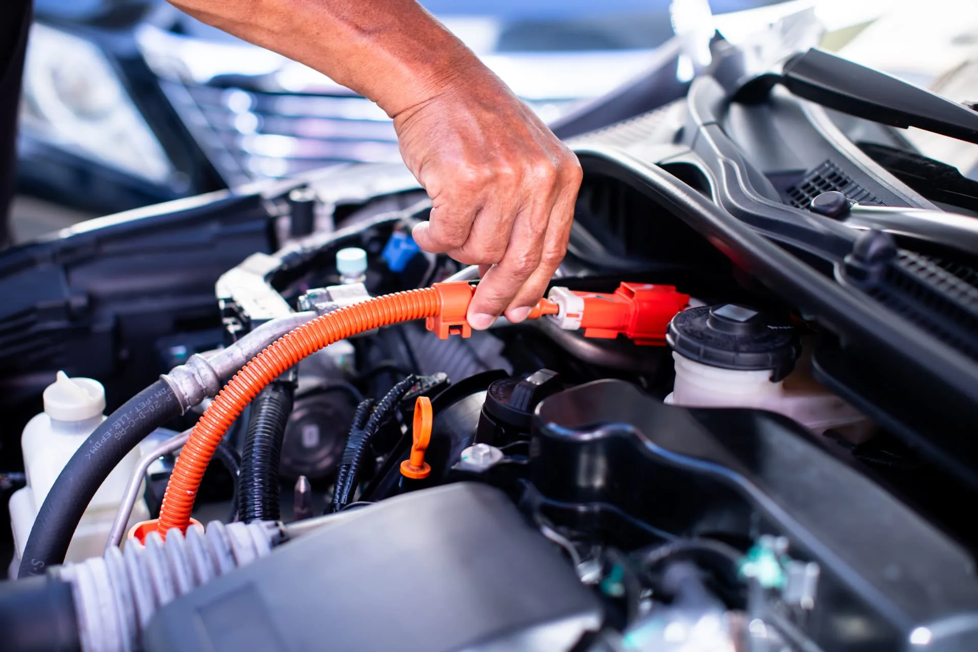 Hybrid vehicle engine bay with orange high voltage cables