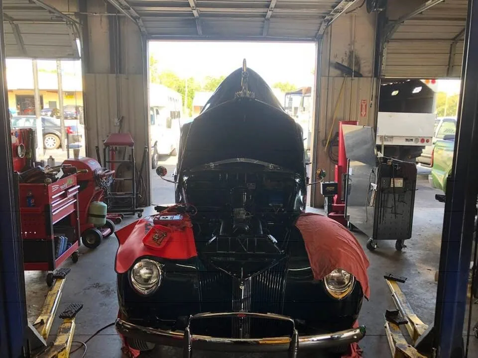 Classic red and black car in the service bay in West Columbia, SC